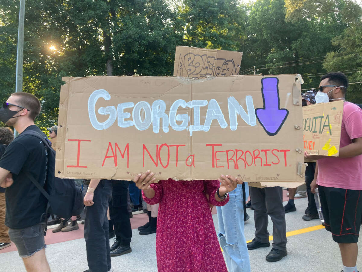 A protester holds up a sign at the March for the Forest, held on June 28, 2023.