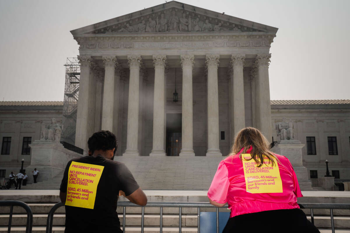 Advocates for student debt relief stand outside of the Supreme Court of the United States on June 29, 2023, in Washington, D.C.