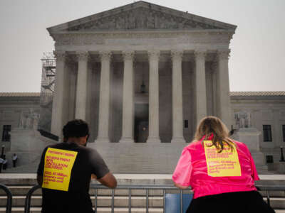 Advocates for student debt relief stand outside of the Supreme Court of the United States on June 29, 2023, in Washington, D.C.