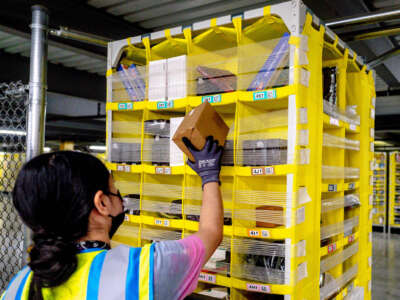 Worker Melissa Navarrete Urena stows goods into a movable pallet at Amazon fulfillment center in Eastvale, California on August 31, 2021.