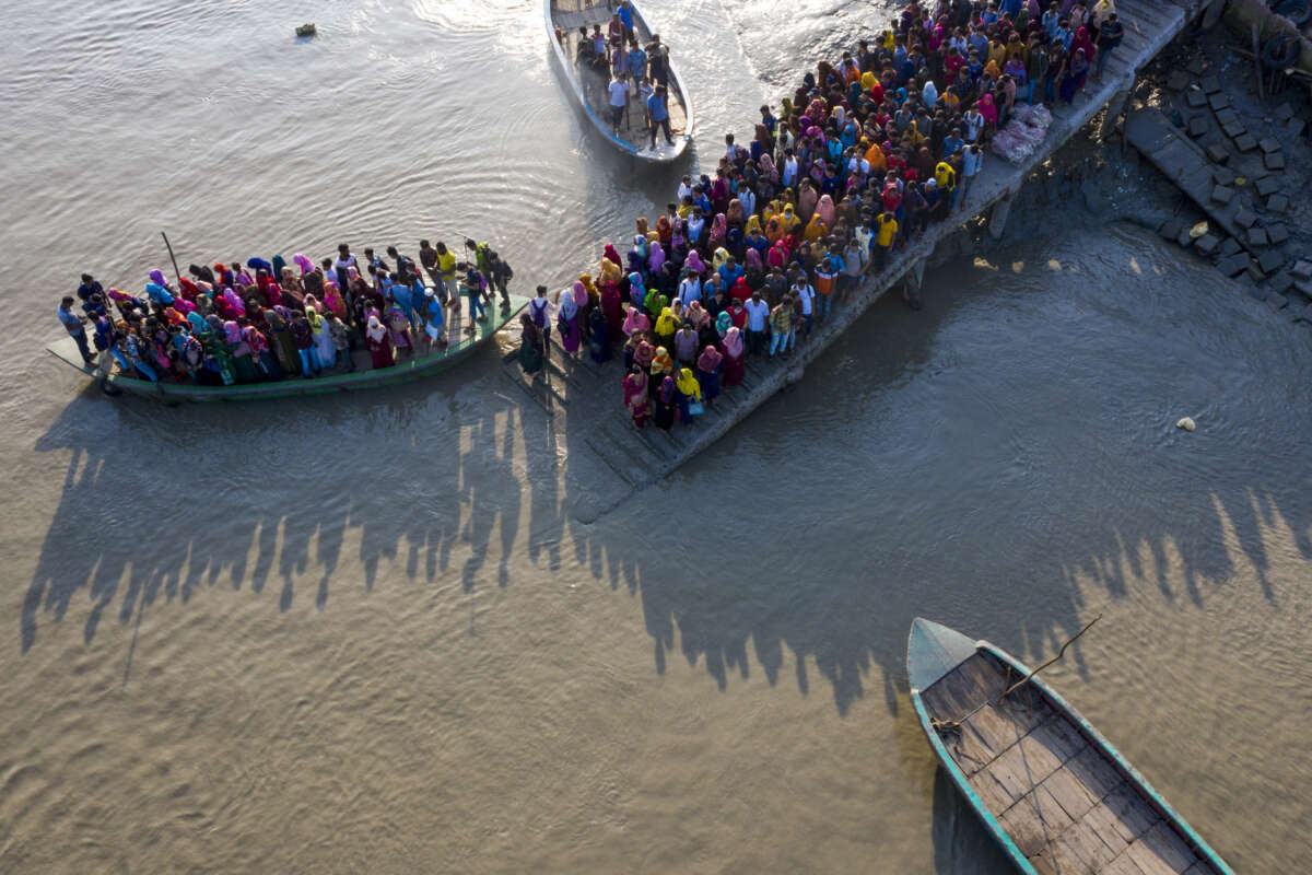 Aerial view of a crowd of climate migrant workers crossing the Poshur river in Bagerhat, Bangladesh on August 28, 2022.