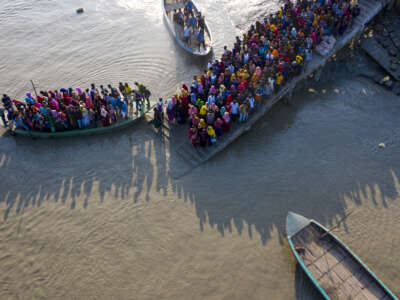 Aerial view of a crowd of climate migrant workers crossing the Poshur river in Bagerhat, Bangladesh on August 28, 2022.
