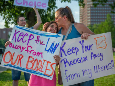 Giuliana Cangelosi, 11, and her mother Nichole Cangelosi share a moment together while attending a protest opposing the Supreme Court's ruling overturning federal protections for abortion rights Friday, June 24, 2022, in Kansas City, Missouri.