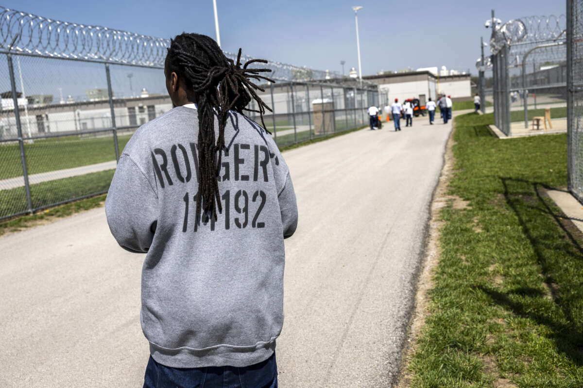 Incarcerated people exercise in the maximum security yard of the Lansing Correctional Facility