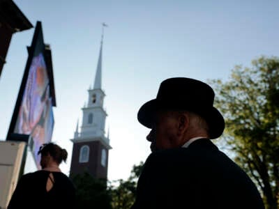 Alum Thomas Black greets guests during the 372nd Commencement at Harvard University.