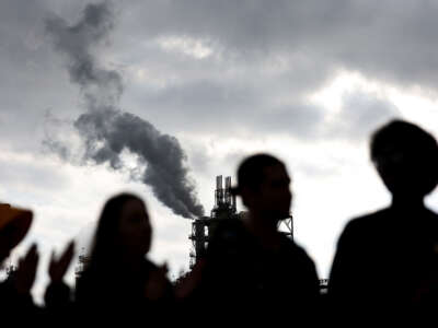 Protestors stand outside the Phillips 66 Los Angeles Refinery Wilmington Plant on November 28, 2022, in Wilmington, California.