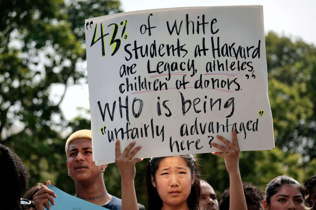A Harvard student holds a sign during a rally protesting the Supreme Courts ruling against affirmative action on July 1, 2023, in Cambridge, Massachusetts.