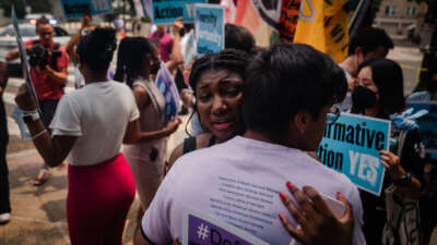 Harvard University students hug during a protest outside of the Supreme Court on June 29, 2023.