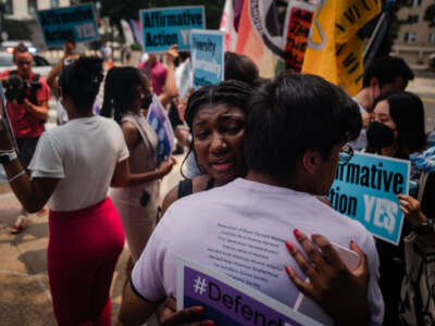 Harvard University students hug during a protest outside of the Supreme Court on June 29, 2023.