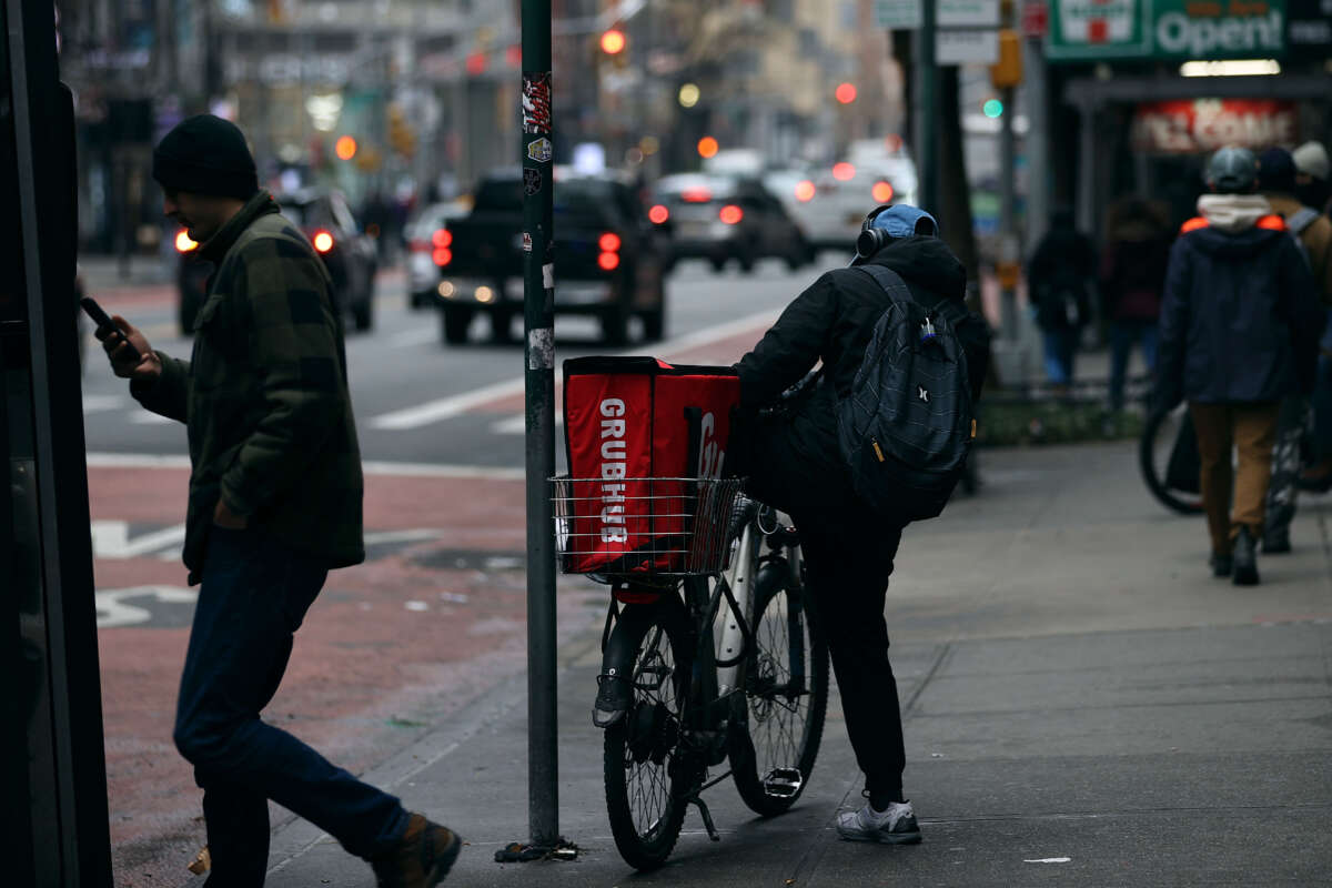 A food delivery person with a bicycle is seen at Times Square in New York City on December 29, 2021.