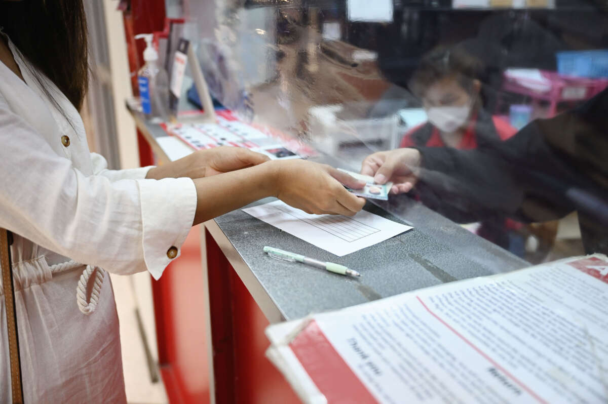 Person presents driver's license at counter