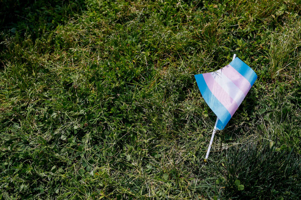 A transgender flag sits on the grass during the 'Trans Youth Prom' outside of the U.S. Capitol building on May 22, 2023, in Washington, D.C.