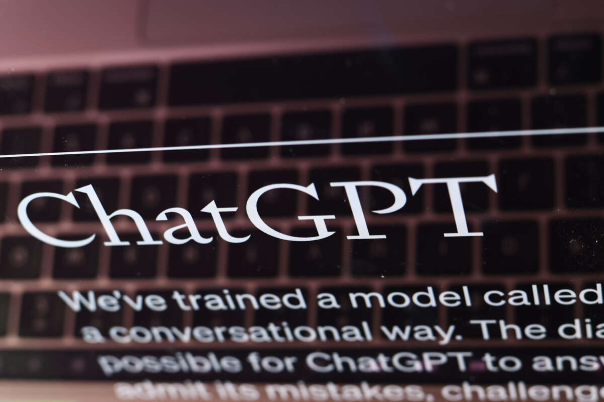 The ChatGPT website is displayed on a laptop screen.