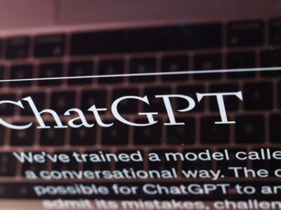 The ChatGPT website is displayed on a laptop screen.