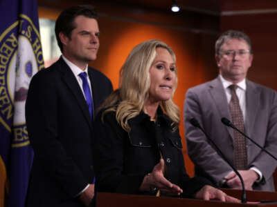 Rep. Marjorie Taylor Greene (middle) speaks as Rep. Matt Gaetz (left) and Rep. Thomas Massie (right) listen during a news conference at the U.S. Capitol on November 17, 2022, in Washington, D.C.