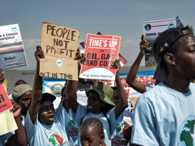 Environmental activists carry posters during a protest to demand for climate action for restoration of Lake Victoria as part of Climate Emergency Day 2023 on July 22, 2023, in Kisumu, Kenya.