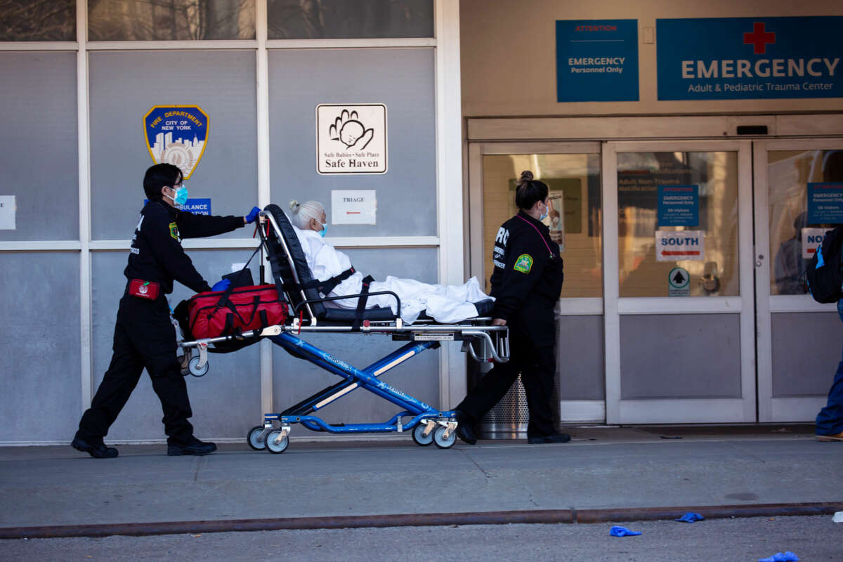 An elderly patient is wheeled into the emergency room of a hospital
