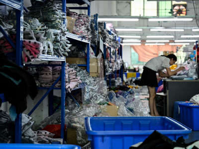 A worker makes clothes at a garment factory that supplies Shein, a cross-border fast fashion e-commerce company in Guangzhou, in China's southern Guangdong province on July 18, 2022.