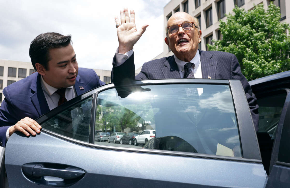 Former New York City Mayor and former personal lawyer for former President Donald Trump Rudy Giuliani (right) leaves the U.S. District Court on May 19, 2023, in Washington, D.C.