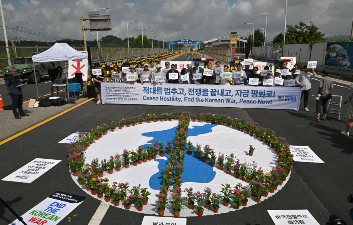 Antiwar activists hold a rally to mark the 70th anniversary of the signing of the Korean Armistice Agreement, near a military check point on the Tongil bridge along the road leading to the truce village of Panmunjom, in the border city of Paju, on July 27, 2023.