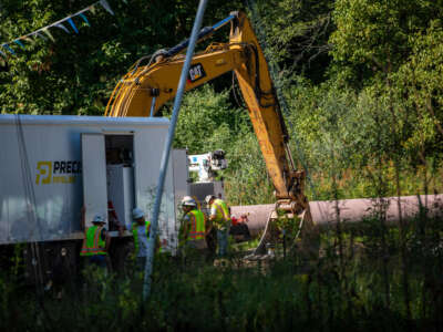 A work crew for Precision Pipeline Company discusses the placement of a section of the Mountain Valley Pipeline that is halted near a wetland area, on August 25, 2022, in Walkersville, West Virginia.