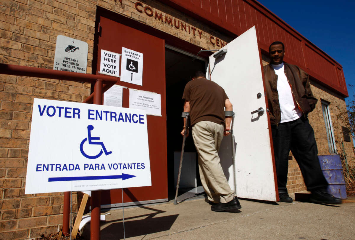 David Caise, right, holds the door for a disabled voter as he leaves the Everman Community Center in Everman, Texas, after casting his ballot on March 4, 2008.