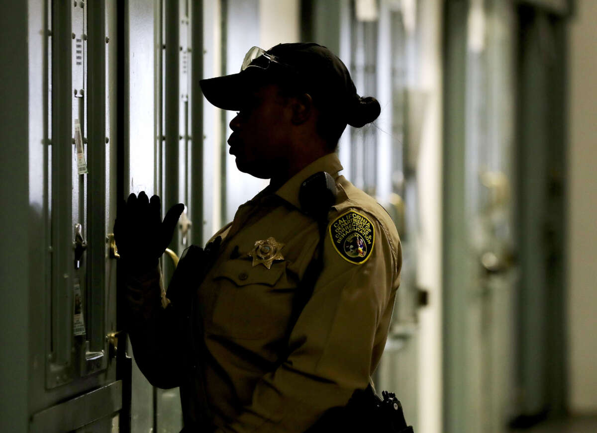 A California Department of Corrections and Rehabilitation officer checks on inmates at the Short-Term Restricted Housing Unit of California State Prison, Sacramento, on April 13, 2023.