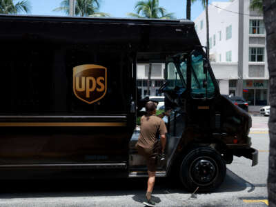 A UPS driver makes a delivery on June 30, 2023, in Miami, Florida.