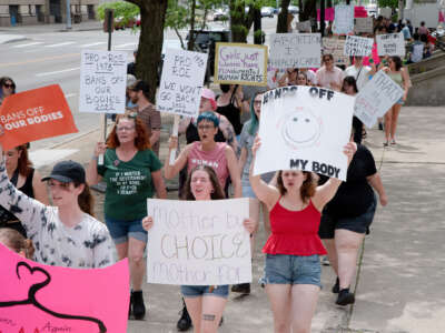 Protesters hold signs at an abortion rights rally in Dayton, Ohio, on May 14, 2022.