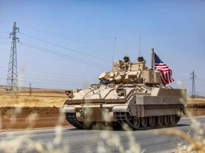 U.S. soldiers in a Bradley Fighting Vehicle (BFV) patrol the countryside in Syria's northeastern Hasakeh province on June 7, 2023.