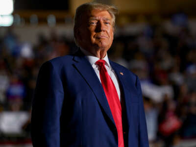 Donald Trump stands before his supporters at an event