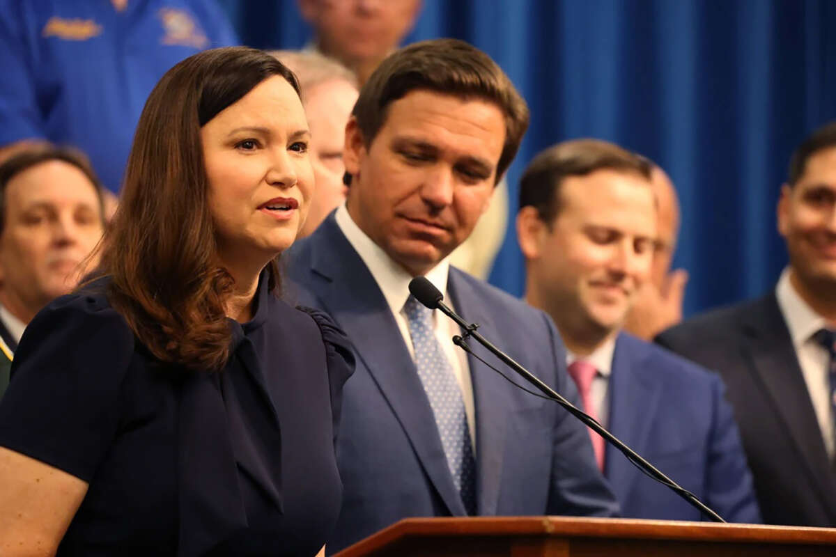 Florida Attorney General Ashley Moody is pictured at a 2021 press conference with Gov. Ron DeSantis.