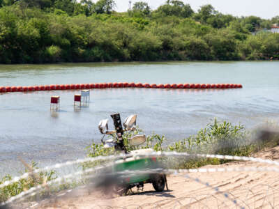 View of a string of buoys placed on the water along the Rio Grande border with Mexico in Eagle Pass, Texas, on July 15, 2023, to prevent entry to the U.S.