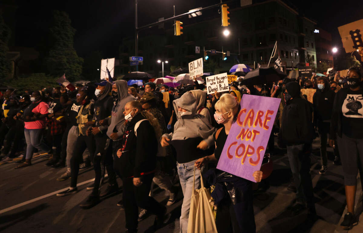 Demonstrators march for Daniel Prude on September 4, 2020, in Rochester, New York. Prude died after being arrested on March 23, by Rochester police officers who had placed a "spit hood" over his head and pinned him to the ground while restraining him.