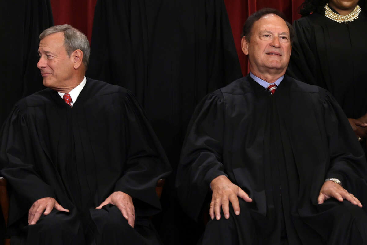 Supreme Court Chief Justice John Roberts (left) and Associate Justice Samuel Alito pose for an official portrait at the East Conference Room of the Supreme Court building on October 7, 2022, in Washington, D.C.
