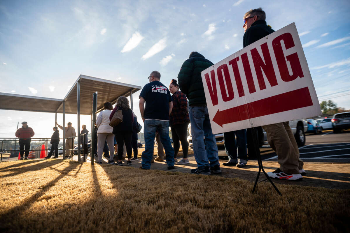 People are seen in line to vote at the sole polling place open for Saturday early voting in Bartow County on November 26, 2022, in Cartersville, Georgia.