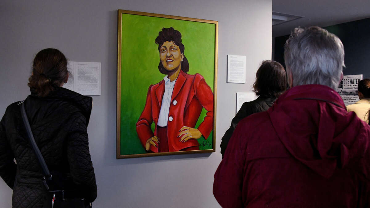 People view a painted portrait of the late Henrietta Lacks
