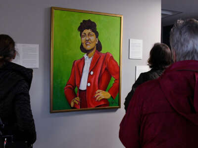 People view a painted portrait of the late Henrietta Lacks