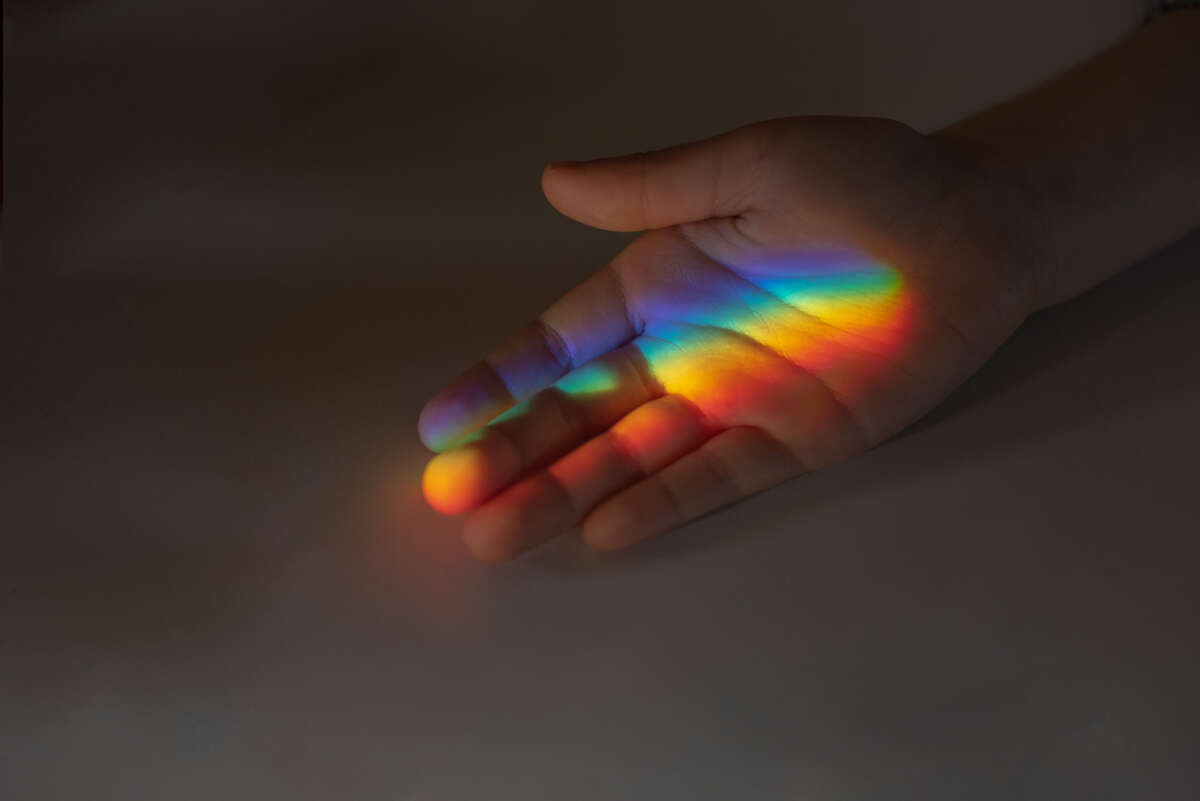 Child's hand with rainbow