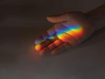 Child's hand with rainbow