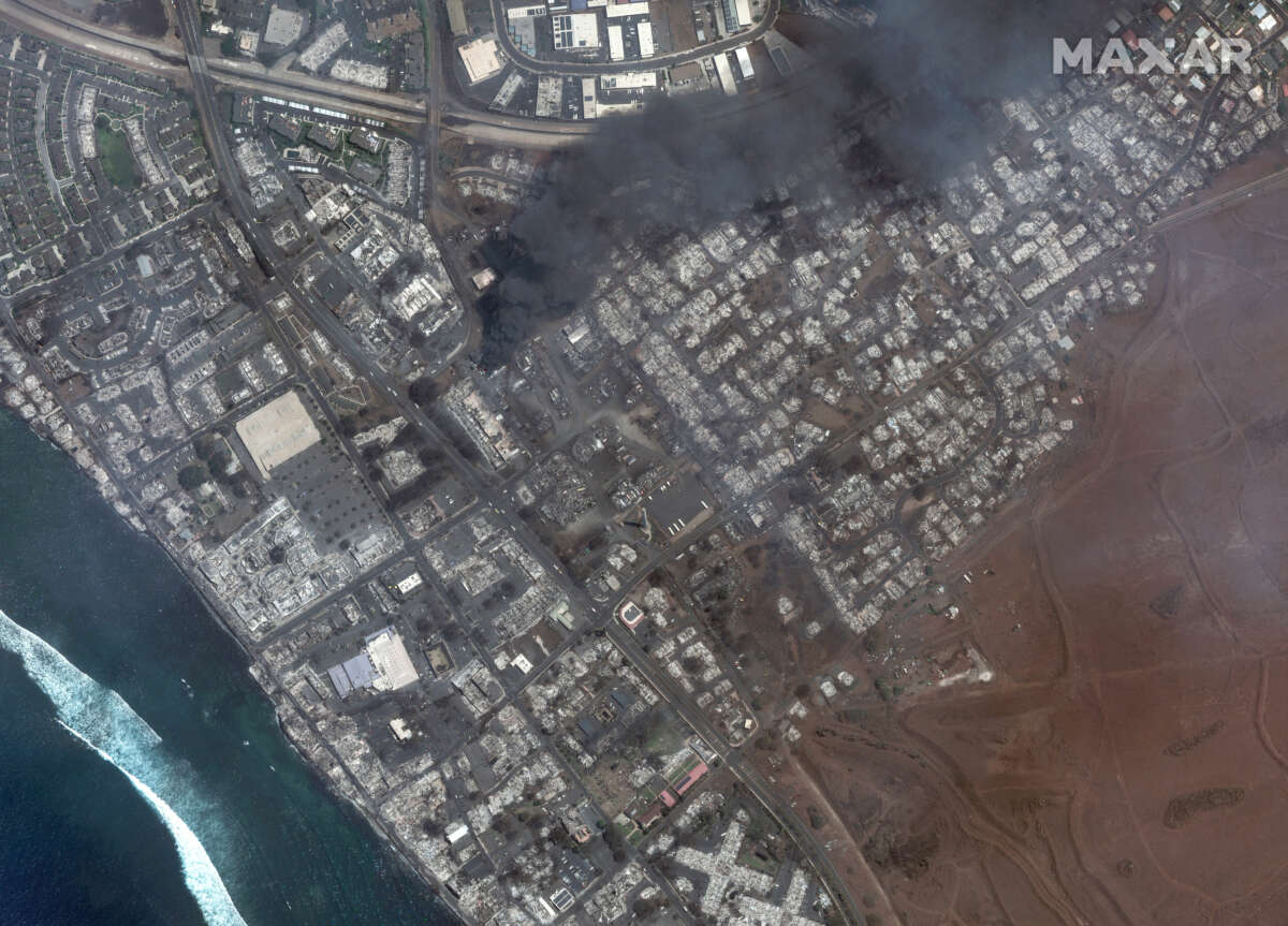 Maxar satellite imagery shows total destruction of the Lahaina square and outlets after the Lahaina Wildfire, with one building still actively burning on August 9, 2023.