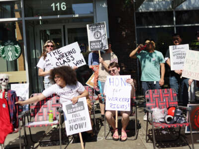 People picket in front of a Starbucks store in the Greektown neighborhood of Chicago, Illinois, on June 24, 2023.