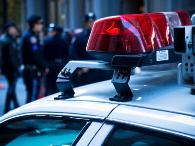 Police car lights close up. A group of police officers on the background.