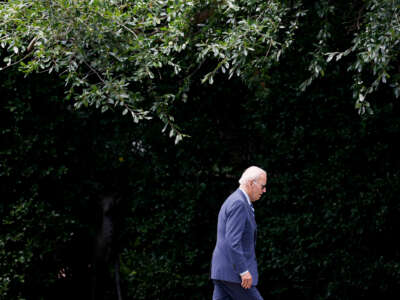 Joe Biden walks amongst greenery