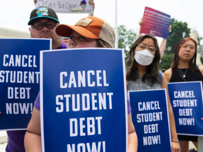 Demonstrators display signs of protest outside the U.S. Supreme Court, on June 30, 2023.