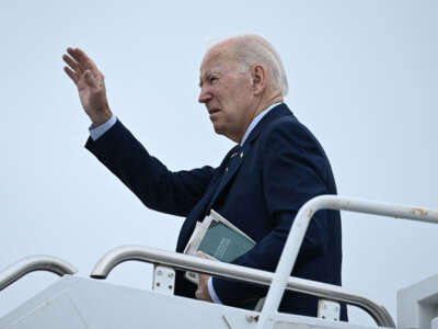 President Joe Biden waves as he departs from Delaware Air National Guard Base in New Castle, Delaware, on August 7, 2023.