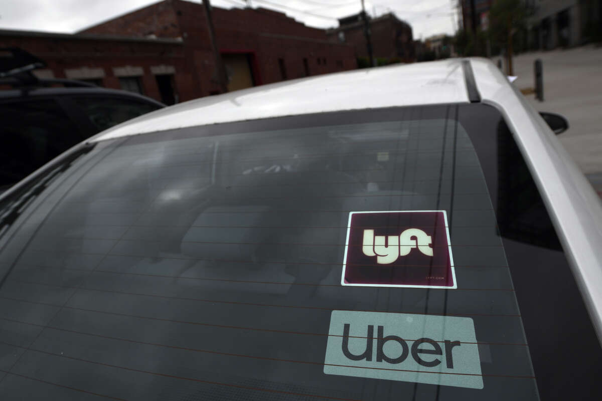 Uber and Lyft stickers are seen on a car in Los Angeles, California, on August 6, 2020.