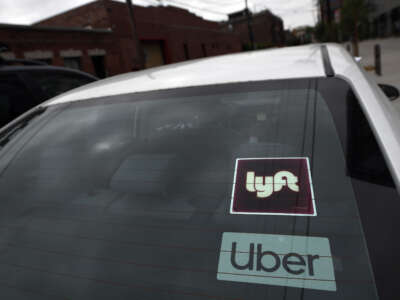 Uber and Lyft stickers are seen on a car in Los Angeles, California, on August 6, 2020.