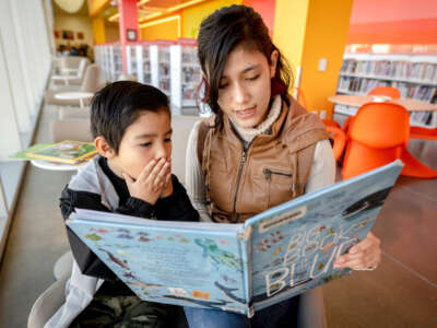 Children read a book at Riverside Main Library in downtown Riverside, California, on January 31, 2023.