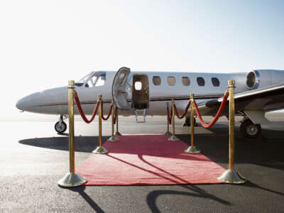 Private jet with red carpet and velvet rope